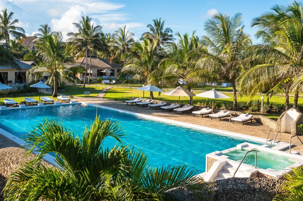 calming palm trees by a beach and swimming pool