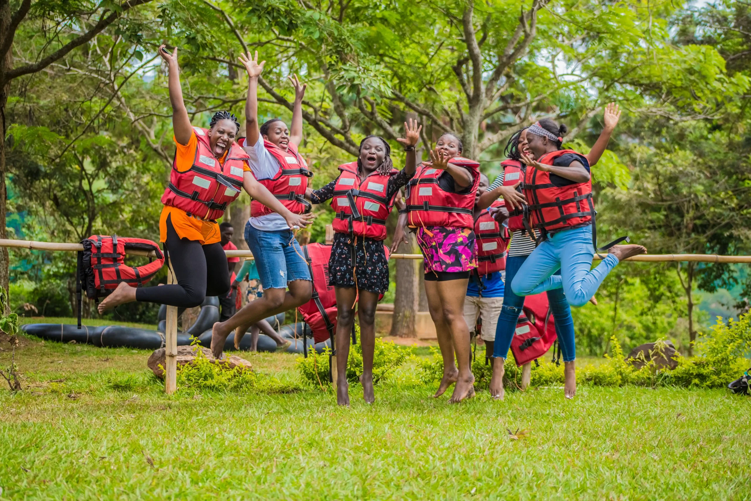 a group of people jumping and in outdoor activites gear